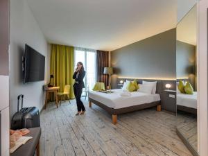 Postel nebo postele na pokoji v ubytování Novotel München Messe
