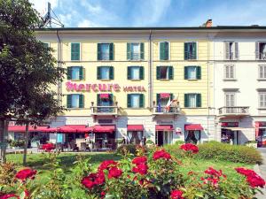 a large yellow building with a sign on it at Hotel Mercure Milano Centro in Milan