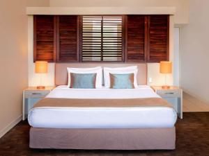 A bed or beds in a room at Novotel Nadi