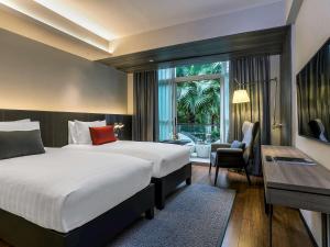 A bed or beds in a room at Pullman Bangkok King Power