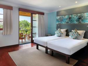 Tempat tidur dalam kamar di Novotel Bali Nusa Dua