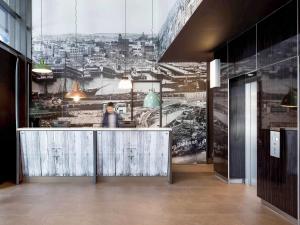 a lobby with a large view of a city at ibis Sydney Barangaroo in Sydney