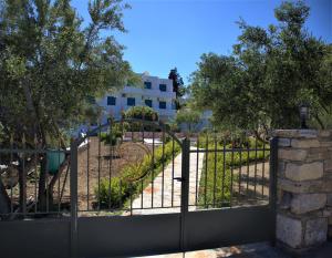a gate to a park with a playground at St.George Valsamitis in Katapola