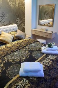 a bedroom with two beds with towels on them at Bane Apartmani in Kraljevo