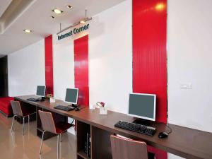 a conference room with two desks with computers on it at Ibis Bangkok Riverside in Bangkok