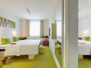 Postel nebo postele na pokoji v ubytování ibis Styles Dortmund West