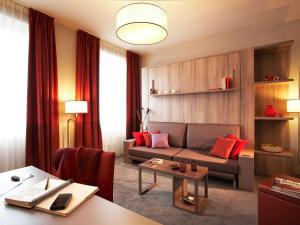 
a living room filled with furniture and a coffee table at Aparthotel Adagio Vienna City in Vienna
