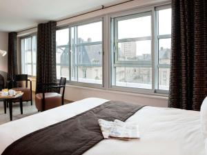 A bed or beds in a room at Hôtel Mercure Thionville Centre Porte du Luxembourg