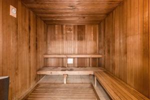 a wooden sauna with a bench in the middle at Broadbeach Holiday Apartments in Gold Coast