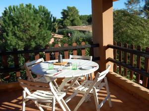 a white table and chairs sitting on a balcony at Appartamenti Brezza di Mare in Monte Nai