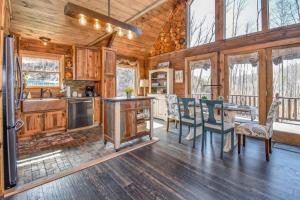a kitchen and dining room in a log cabin at Bear Sightings! 8 mins to downtown Gatlinburg, Kids Cave, Theatre, Treehouse! in Gatlinburg