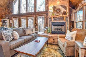 a living room with a couch and a fireplace at Bear Sightings! 8 mins to downtown Gatlinburg, Kids Cave, Theatre, Treehouse! in Gatlinburg