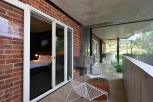 a brick house with glass doors and chairs on a patio at Riverview on Mount Street in Perth