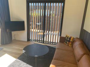 a living room with a couch and a table at Joan's @ 21 in Wanaka