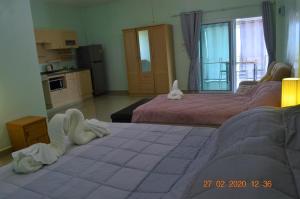 a room with two beds and a cat laying on the floor at Briya Beachfront Residence in Sichon