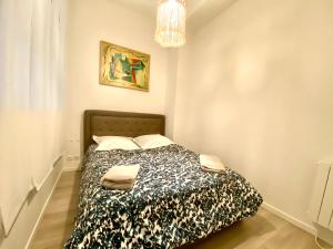 En eller flere senger på et rom på ARC DE TRIOMPHE-CARNOT Luxury & Design