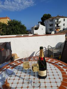 a bottle of wine sitting on a table with two glasses at La Cala sunny rooftop in Mijas Costa