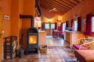 a living room with a wood stove in a room at Villa Waldeslust in Beaufort