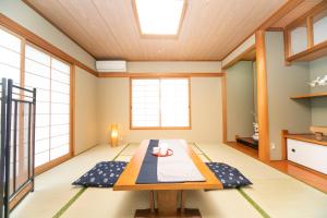 a dining room with a table and windows at Awaji Seaside Resort in Ikuha in Ikuha