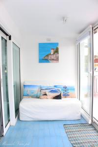 a bed in a room with a large window at La Casa di MaPi in Salerno