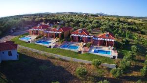 an aerial view of a house with two swimming pools at Catherine Villas in Maronia