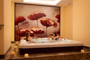 two women in a bath tub in a bathroom at Cleopatra Luxury Resort Sharm El Sheikh in Sharm El Sheikh