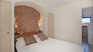 a bedroom with a white bed in a room at locations calenzana in Calenzana