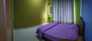 a bedroom with a purple bed and a shower at Mintsuite homestay in Putrajaya