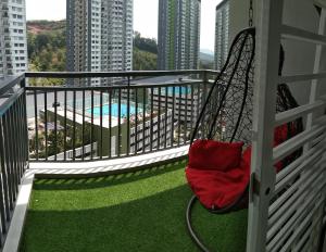 a hammock on a balcony with a pool at Mintsuite homestay in Putrajaya