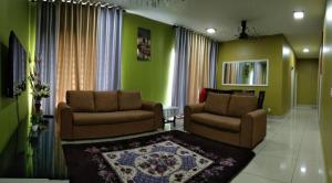 a living room with two chairs and a rug at Mintsuite homestay in Putrajaya