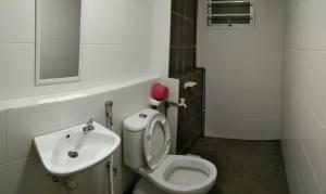 a small bathroom with a toilet and a sink at Mintsuite homestay in Putrajaya