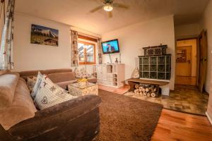 a living room with a couch and a fireplace at Ferienwohnung Wörnerblick in Mittenwald