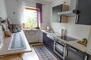 a small kitchen with a sink and a stove at Ferienwohnung am Ilztal in Hutthurm