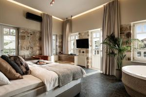 Ένα ή περισσότερα κρεβάτια σε δωμάτιο στο Divino Suites Chania