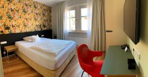 Postel nebo postele na pokoji v ubytování Hotel am Torturm