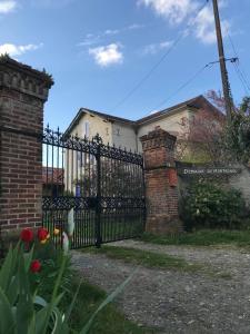 a black wrought iron fence in front of a house at Domaine de Montagnol in Sauveterre