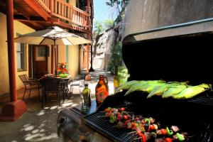 a grill with vegetables on it next to a patio at Eldorado Suites Hotel in Bisbee