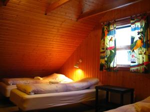 A bed or beds in a room at Guesthouse Húsid