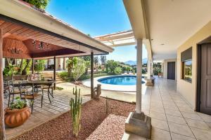 an outdoor patio with a table and chairs and a pool at La Riviera Hotel in San José