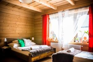 a bedroom with two beds and a window at U Dziadka in Chochołów