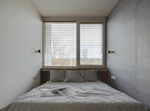 a bedroom with a bed with two books on it at Bosky Apartament in Gródek Nad Dunajcem