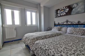 Posteľ alebo postele v izbe v ubytovaní Apartamentos Aloha2 El Puerto de Santa Maria
