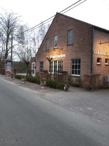 a brick building on the side of a street at Vakantiewoning De Kleine Duinberg - Chalet Nr 11 in Retie