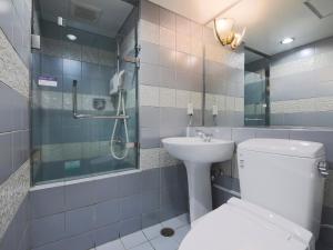 a bathroom with a toilet and a sink and a shower at APA Hotel Yamagata Ekimae Odori in Yamagata