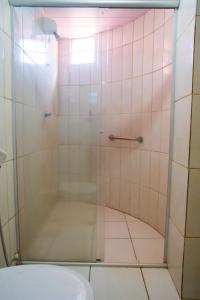a bathroom with a shower with a toilet at Hotel Iguacu in Campo Grande