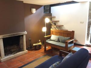 a living room with a couch and a fireplace at Quinta Travessa in Vieira do Minho