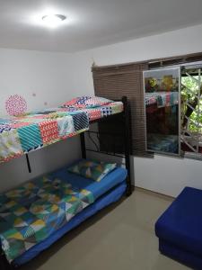 two bunk beds in a room with a window at Casa Campestre Rivera in Rivera