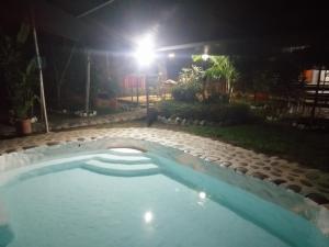 a swimming pool in a backyard at night at Casa Campestre Rivera in Rivera