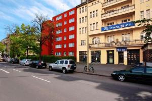 a street with cars parked in front of a building at Hotel Central Inn am Hauptbahnhof Pension in Berlin