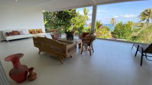 a living room with a piano and a large window at Kata Top Villas in Kata Beach